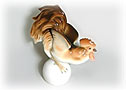 Silly playful rooster!  This inexpensive porcelain rooster is clearly having fun as he rolls across the Russian countryside on a ball.