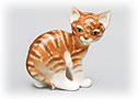  This brightly striped orange kitten is a Lomonosov porcelain Kitten figurine with a cagey expression. 