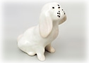 This little white porcelain Bolognese dog looks up to his Master just like the real life pup.