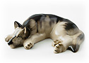  This black and tan porcelain German Shepherd figurine is taking a snooze.