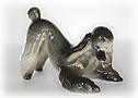 This dark-colored  or silver Lomonosov porcelain Poodle figurine demonstrates the most common of dog bows, the classic play bow.