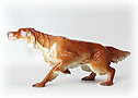 This Lomonosov porcelain Irish Setter crouches low to the ground with one foot raised, ready to retrieve pheasant or quail.